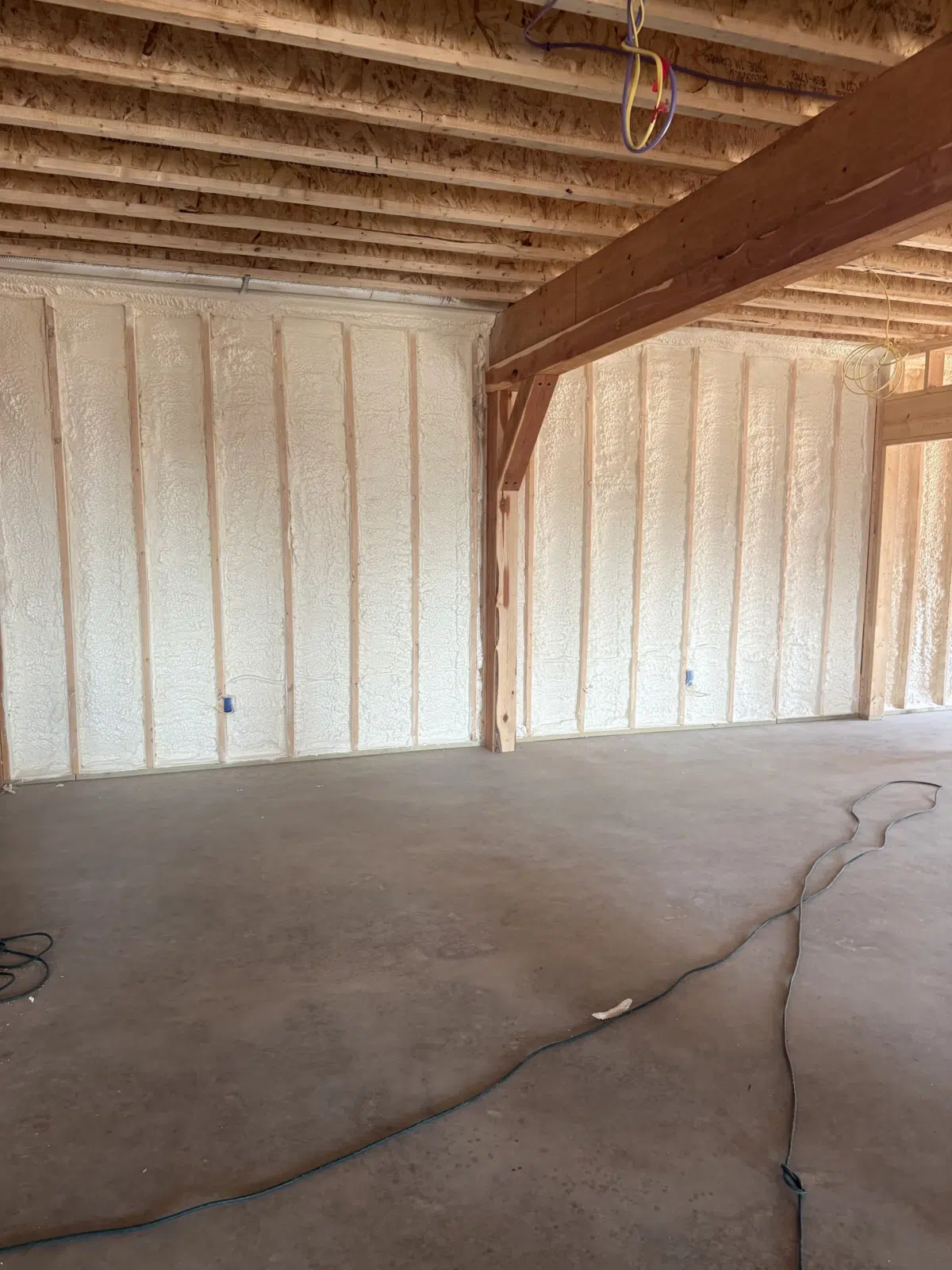 Foam-insulated walls inside an unfinished post-and-beam interior — Missouri Foam Solutions in Thayer