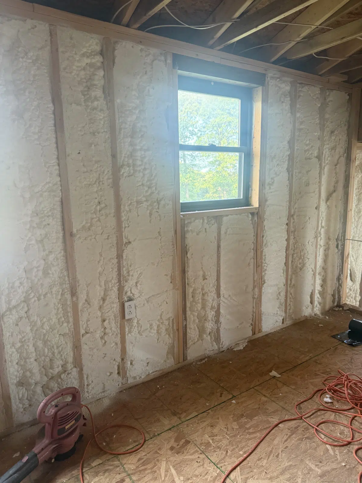 Spray foam insulated basement wall framing around a window — Missouri Foam Solutions in Thayer